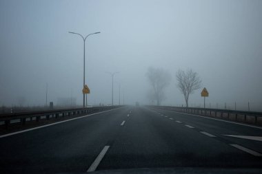 Driving in foggy weather on the highway. Driving in autumn and winter weather.