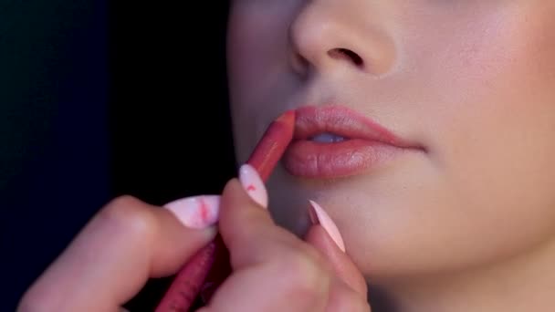 Primeros planos Mujer blanca obtiene labios coloreados con lápiz rosa natural por profesional — Vídeos de Stock