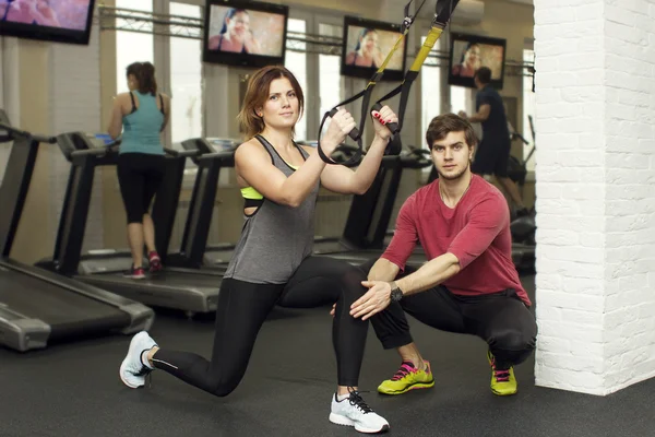 Beautiful sports fitness couple in the gym. Fitness instructors with additional equipment — Stock Photo, Image