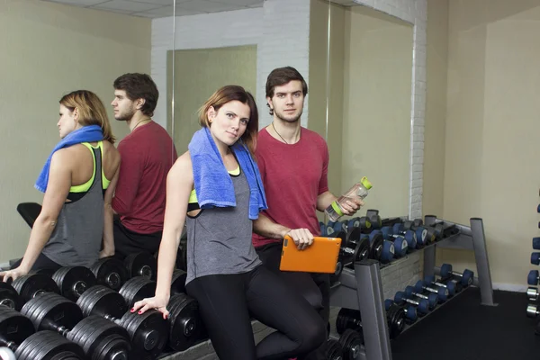 beautiful sports fitness couple in the gym. Fitness instructors with additional equipment