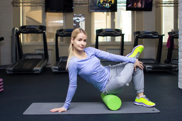 Beautiful blond athletic girl in a gym doing exercises — Zdjęcie stockowe