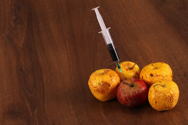 Hormone Apple on the Wood — Stock Photo, Image