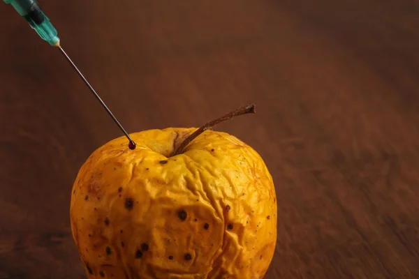 Hormone Apple on the Wood — Stock Photo, Image