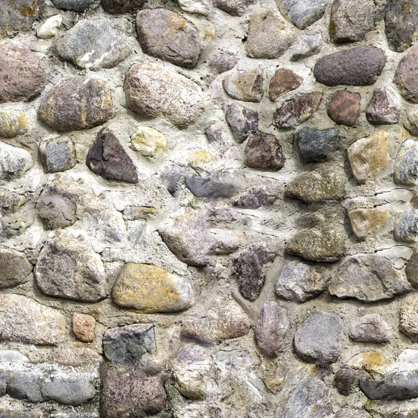 Bezešvá textura starobylé zdi s barevnými kameny — Stock fotografie
