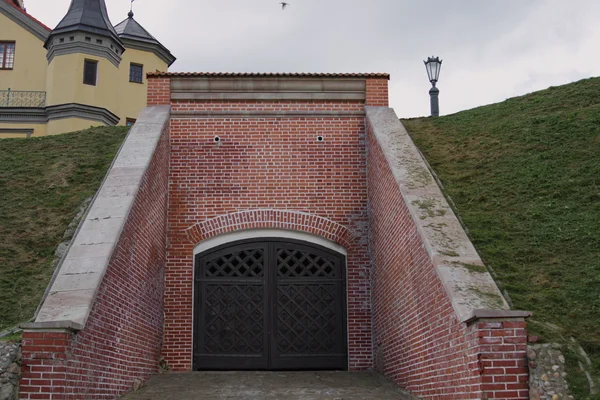 Nesvizh, Bielorrússia - 03 de agosto de 2016: O portão na saída da parte subterrânea do castelo de Nesvizh — Fotografia de Stock