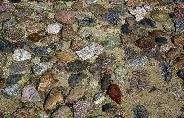 Textura starobylé kamenné dlažby s pískem a barevné kameny — Stock fotografie