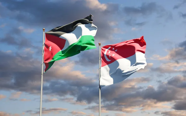 아름다운 요르단과 싱가포르의 깃발이 하늘을 배경으로 있습니다 — 스톡 사진