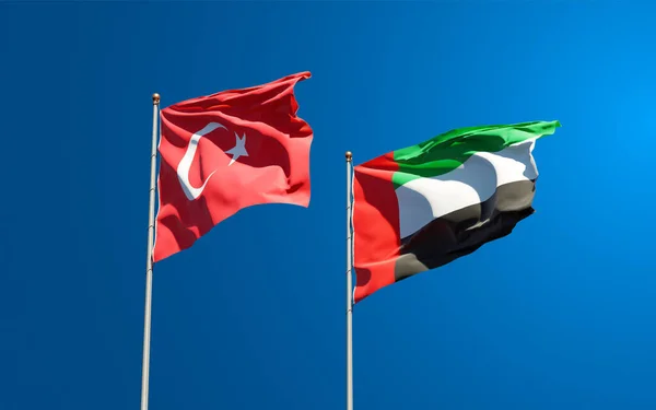Gökyüzü arka planında Türkiye ve BAE Birleşik Arap Emirlikleri 'nin güzel ulusal bayrakları birlikte görülüyor. 3B sanat eseri konsepti.
