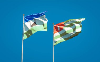 Lesotho ve Abhazya 'nın güzel ulusal bayrakları gökyüzü arka planında birlikte. 3B sanat eseri konsepti.