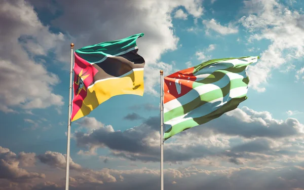 美丽的莫桑比克国旗和阿布哈兹国旗在天空的背景下相映成趣 3D艺术品概念 — 图库照片