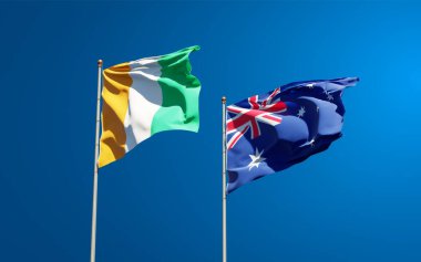 Gökyüzü arka planında Cote d 'Ivoire ve Avustralya' nın güzel ulusal bayrakları birlikte. 3B sanat eseri konsepti. 