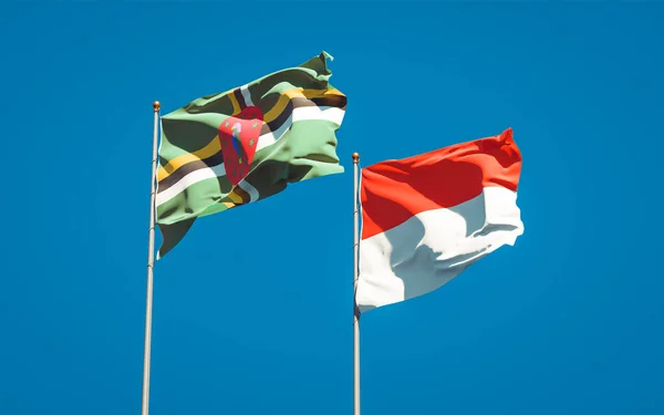 아름다운 인도네시아 국기와 도미니카 국기가 하늘을 배경으로 있습니다 — 스톡 사진