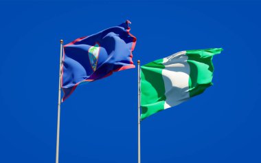 Nijerya ve Guam 'ın güzel ulusal bayrakları gökyüzü arka planında birlikte. 3B sanat eseri konsepti. 