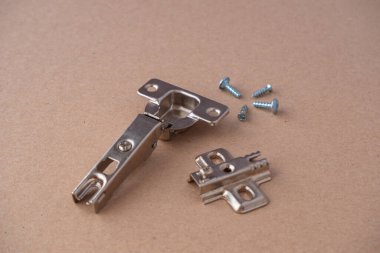 Metal mobilyalar ve mutfak dolabı menteşeleri karton arka planda.