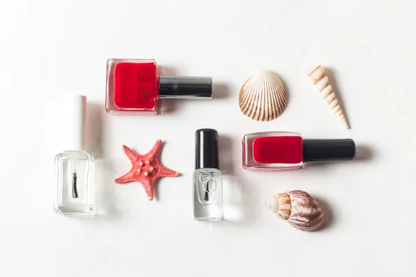 Beauty Flat Lay Red Translucent Nail Polishes Next Seashells White — Stock Photo, Image