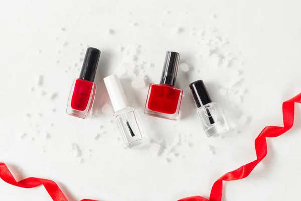 Beauty Flat Lay Red Translucent Nail Polishes Next Red Ribbon — Stock Photo, Image