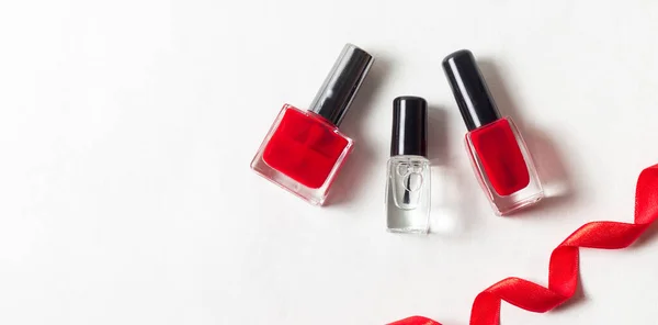 Beauty Flat Lay Red Transparent Nail Polishes Next Red Ribbon — Stock Photo, Image