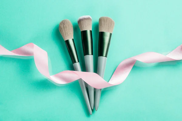 Makeup Brushes Pink Ribbon Turquoise Background Natural Beauty Concept — Stock Photo, Image