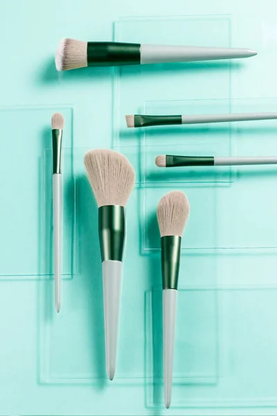 Flat Lay Makeup Brushes Pieces Glass Turquoise Background Cosmetic Products — Stock Photo, Image