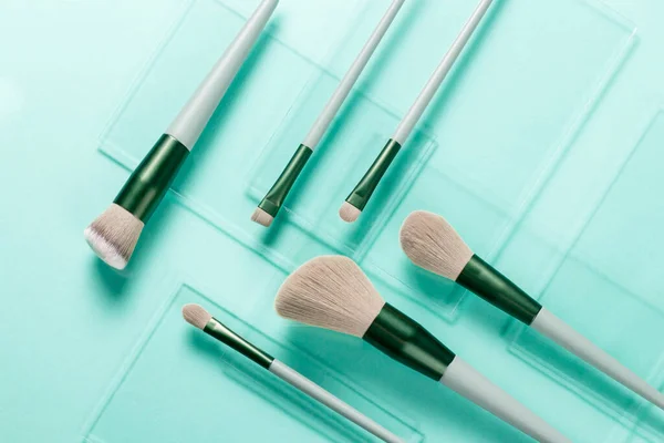 Flat Lay Makeup Brushes Pieces Glass Turquoise Background Cosmetic Products — Stock Photo, Image