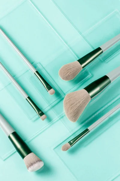 Flat Lay Makeup Brushes Pieces Glass Turquoise Background Cosmetic Products — Stock Photo, Image