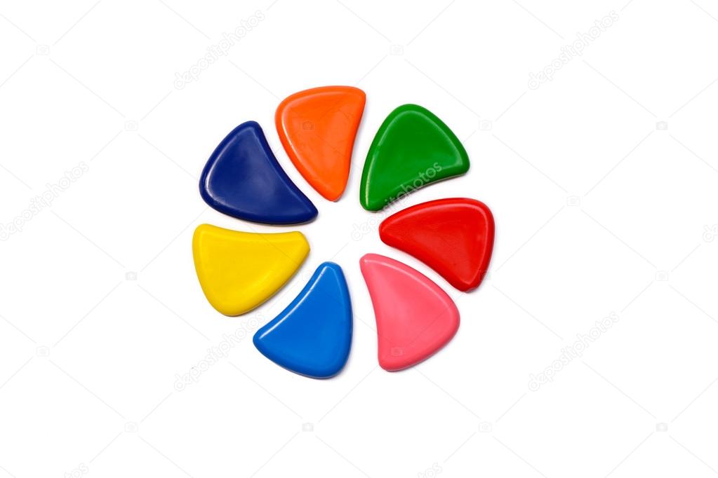 Bunch of different  multicolored wax pencils forming circle on white