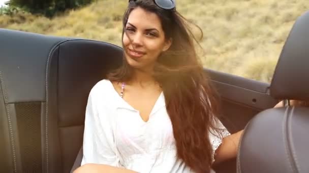 Young woman at the backseat of a convertible. summer feeling — Stock Video