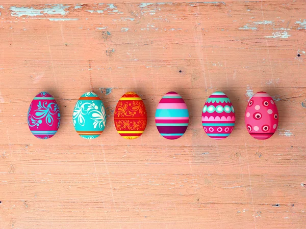 Ovos de Páscoa em fundo de mesa de madeira — Fotografia de Stock