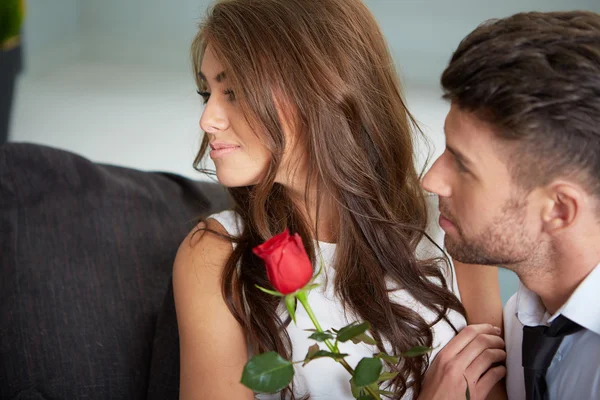 Portrait of two young people holding a rose — Stock Photo, Image