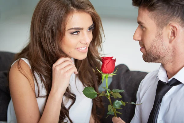 Portrait of two young people holding a rose Stock Photo