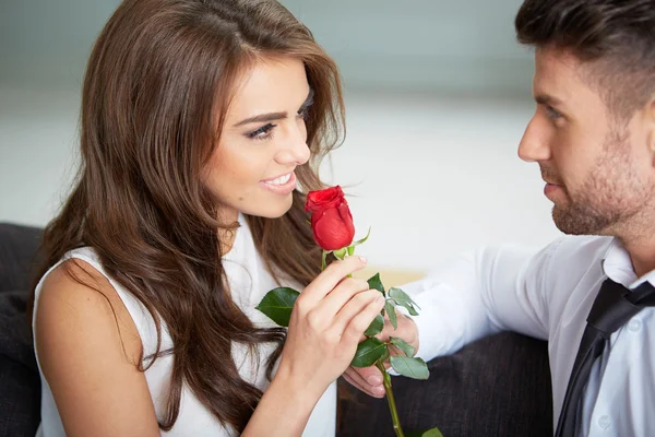 Portrait of two young people holding a rose Royalty Free Stock Photos