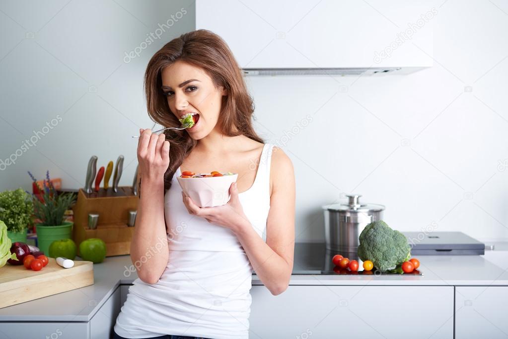 woman is eating a salat in bowl