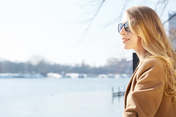 Smiling redhead outdoors backlit by sun — Stock Photo, Image