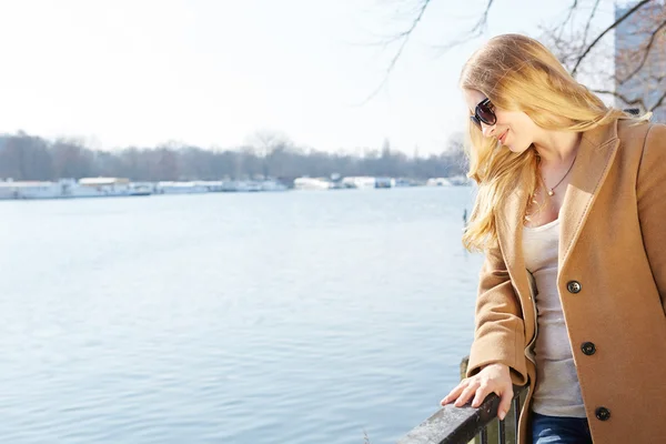 Smiling redhead outdoors backlit by sun — Stock Photo, Image