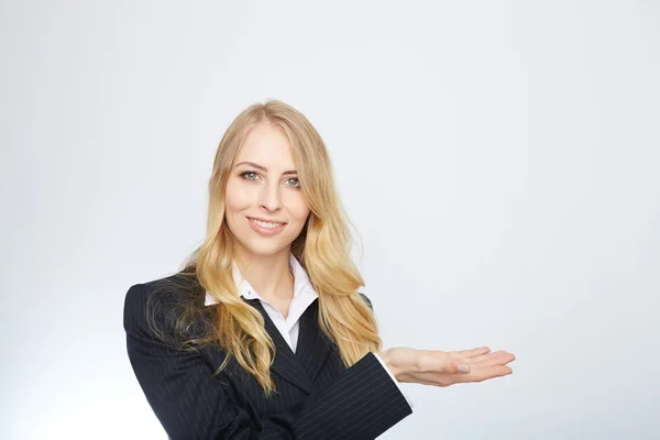 Young blonde woman in a suit, with her hand outstretched. — Stock Photo, Image