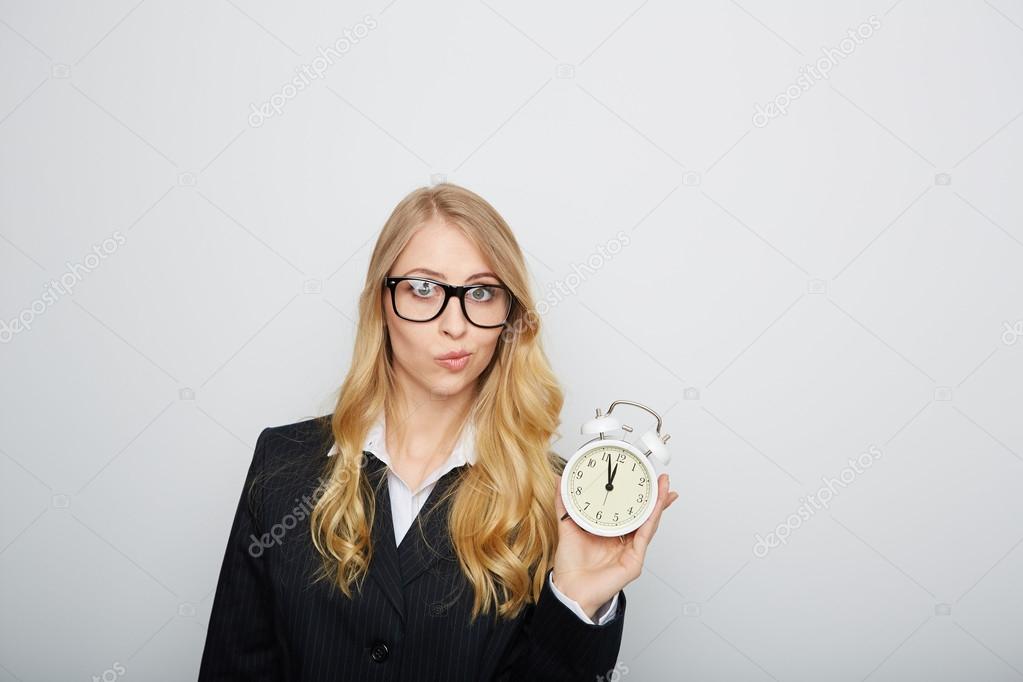 Full isolated portrait of a beautiful caucasian businesswoman locking at the clock. highnoon