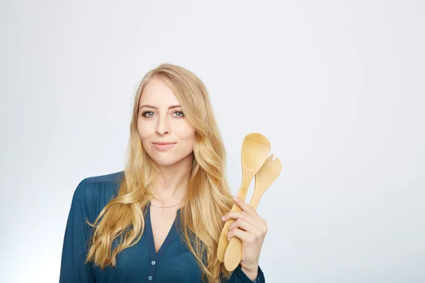 Young woman holding a wooden spoon, isolated. — Stock Photo, Image