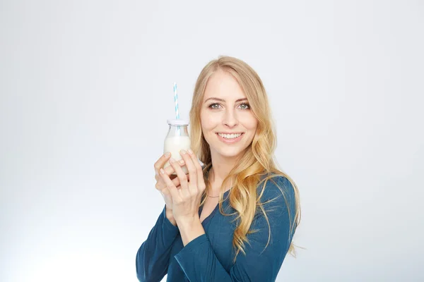 Pretty woman holds glass of delicious and pasteurized milk — Stock Photo, Image