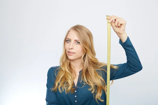 Young woman with a tape measure — Stock Photo, Image