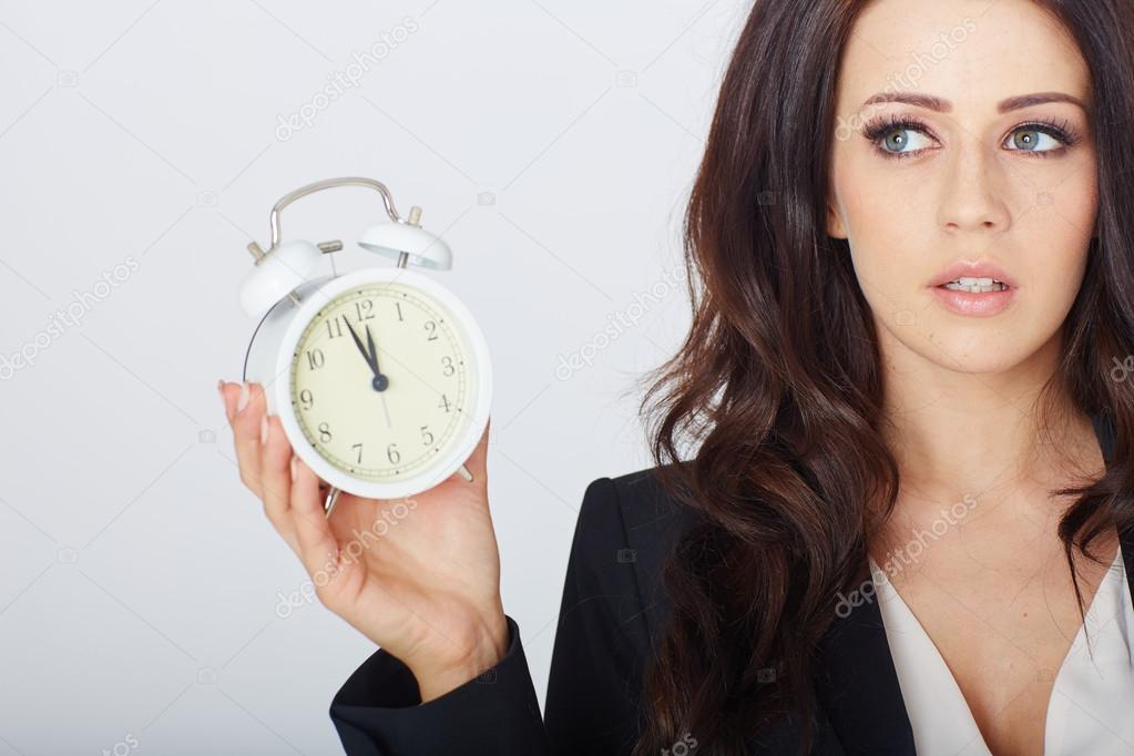 Young businesswoman with an alarm clock