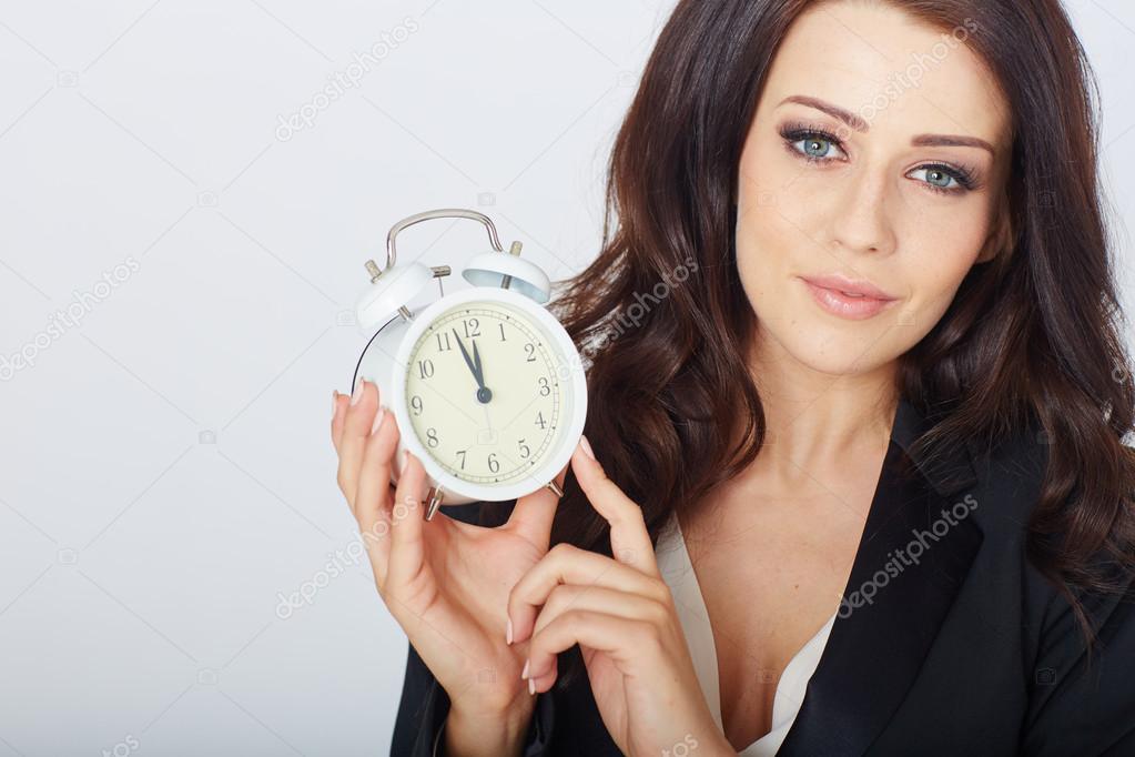 Young businesswoman with an alarm clock