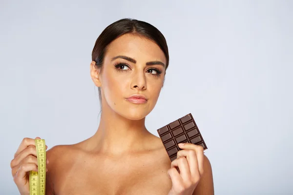 Portrait of a brunette young woman with chocolate — Stock Photo, Image
