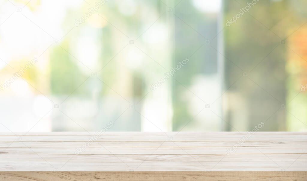 Empty wood table top on blur abstract green garden from window view in the morning.For montage product display or design key visual layout