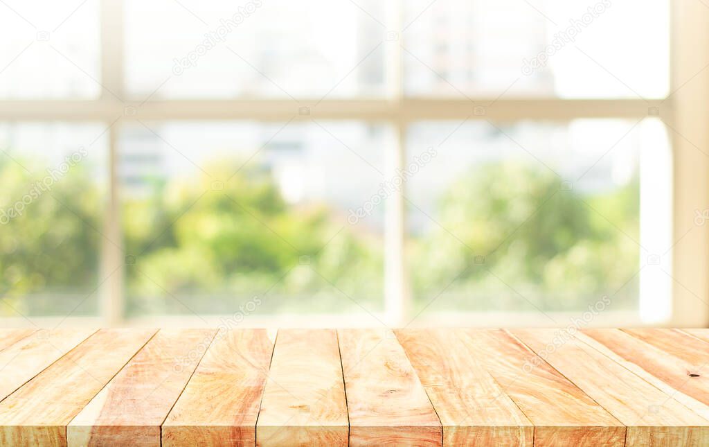 Empty wood table with blur  big window view background.For montage product display or design key visual layout.