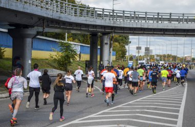 KYIV, UKRAINE - OCTOBER 6, 2019: Wizz Air city marathon. Running race people competing in fitness and healthy active lifestyle feet on road, back view