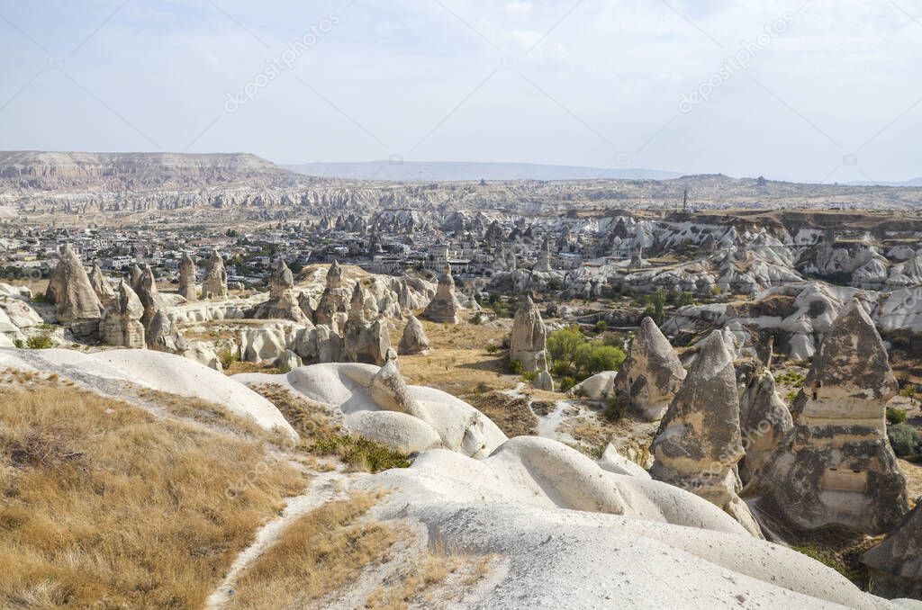 Unique fancy geological mountain formations with dovecotes of the Pigeon valley in Goreme, Cappadocia, Turkey