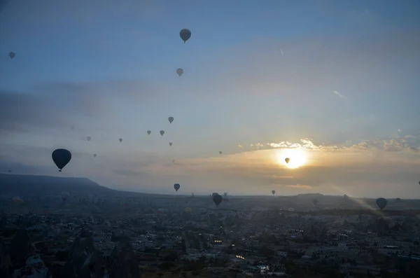多彩的热气球在雾蒙蒙的黎明时分飞越高山和卡帕多西亚山谷 — 图库照片