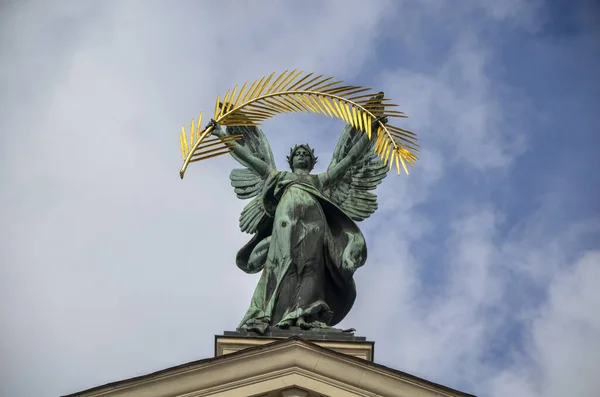 Bronze sculpture of Glory, with a gold palm branch, and wings on the roof of the Opera and Ballet Theatre in Lviv, Ukraine
