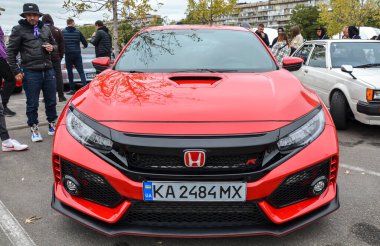 Kırmızı Honda Civic Type yüksek performanslı hatchback, geniş arka kanadı, üçlü outlet egzozu ve fonksiyonel aerodinamik gövde kiti ile agresif stiliyle bilinir.