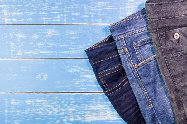 Jeans on a blue wooden background — Stock Photo, Image